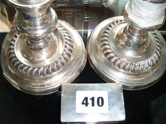 Pair Edwardian silver candlesticks (a.f) and a silver match box case(-)